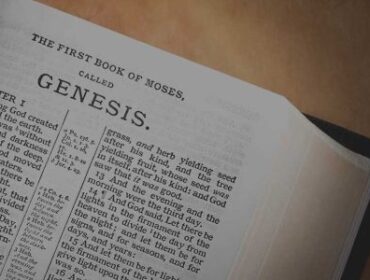Image of the Bible opened with a chapter from Romans displayed