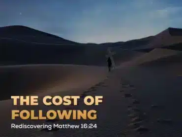 Man following footsteps carrying cross.