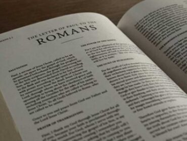 Picture of the Bible opened to the book of Romans
