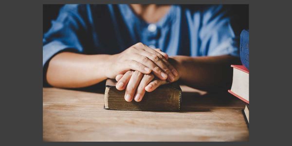 bible-word-research-covenant Man with his hands on the Bible reading about the covenant